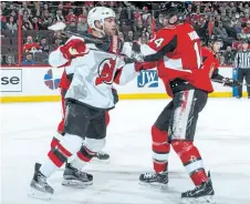  ?? NHLI VIA GETTY IMAGES ?? Ottawa’s Alex Burrows, right, tussles with New Jersey’s Taylor Hall on Wednesday in Ottawa. Burrows has been suspended for 10 games after punching and kicking Hall in the head.