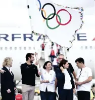  ??  ?? Taking the baton: Mayor of Paris Anne Hidalgo with the Olympic flag yesterday