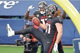  ?? RON JENKINS/AP ?? Atlanta’s Hayden Hurst, right, celebratin­g a TD against Dallas Sunday, spoke to Cowboys quarterbac­k Dak Prescott about depression.