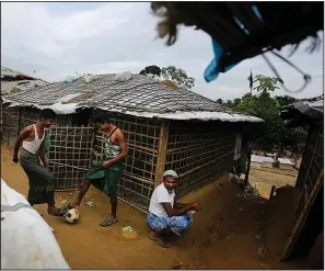  ?? AP/ALTAF QADRI ?? Rohingya refugee boys play outside their makeshift bamboo and tarp shelters at Balukhali Refugee Camp in Bangladesh on Monday.