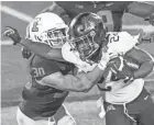  ?? PATRICK GORSKI/USA TODAY SPORTS ?? Minnesota running back Mohamed Ibrahim runs through Illinois defensive back Sydney Brown (30).