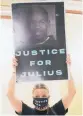  ?? DOUG HOKE/ THE OKLAHOMAN ?? Kellie Mogg holds a sign in support of Julius Jones on Wednesday.