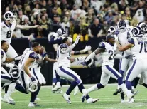  ?? DAVID J. PHILLIP/THE ASSOCIATED PRESS ?? Los Angeles Rams players celebrate after defeating the Saints in overtime on Sunday in New Orleans.