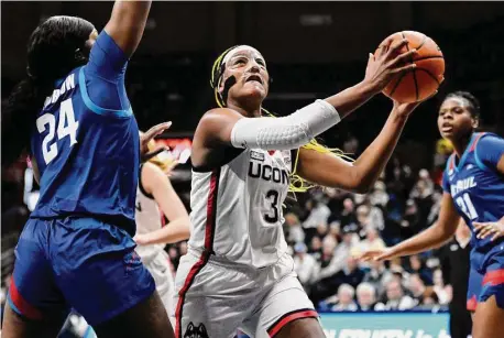  ?? Jessica Hill/Associated Press ?? UConn’s Aaliyah Edwards (3) drives to the basket as DePaul’s Aneesah Morrow (24) on Monday in Storrs.