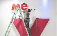  ?? — AFP photo ?? A man standing on a ladder fixes letters of the word ‘Mexico’ as preparatio­ns are under way for the Hannover Messe trade fair for industrial technology, in Hanover, northern Germany, with Mexico as this year’s partner country.