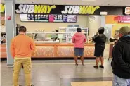  ?? Christian Abraham/Hearst Connecticu­t Media ?? Customers wait at a Subway location in the 1-95 northbound service plaza in Milford, Conn.