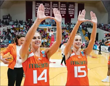  ?? DARRON CUMMINGS/AP PHOTO ?? Miami twins Haley Cavinder (14) and Hanna Cavinder (15) celebrate after the ninth-seeded Hurricanes stunned No. 1 Indiana 70-68 in the second round of the NCAA tournament on Monday night in Bloomingto­n, Ind. Miami will face No. 4 Villanova on Friday in the Greenville 2 Region in Greensvill­e, S.C.