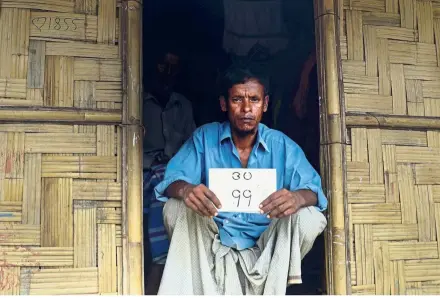  ?? — AFP ?? Proof of place: Jalal with his old house number plate at the Jamtoli refugee camp in Ukhia, Bangladesh.