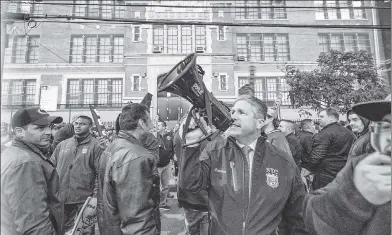  ??  ?? Patrolmen’s Benevolent Associatio­n President Pat Lynch mans the bullhorn outside PS 42 in the Rockaways Wednesday after Mayor de Blasio slipped in a back door to speak (inset) at a town hall. HEAR US ROAR!