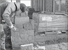  ??  ?? ABOVE: Zach Chubb of Chubb Constructi­on does stone work around porch pillars on one of the duplex units at Joe Wright Village across from the Coosa Valley fairground. The first six units in the gated public housing community, three single-family homes...