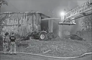  ?? SEAN D. ELLIOT THE DAY ?? Crews fight a fire Sunday at a commercial garage at 81 Corning Road in Norwich. The City of Norwich fire department was assisted by the East Great Plain, Yantic, Taftville and Laurel Hill volunteer department­s, with mutual aid from the Mohegan Tribe and Sub Base department­s.