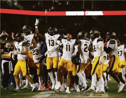  ?? Stephen Lam / The Chronicle ?? Members of the Cal football team celebrate on the sideline during the fourth quarter of the Bears’ 41-11 rout of Stanford.