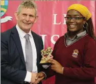  ??  ?? Ted Owens, CE of Cork ETB, presenting the Cultural Award to Faith Omoro.