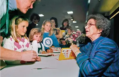  ?? Vern Fisher/The Monterey County Herald via AP, File ?? ■ In this April 19, 1998, file photo, Beverly Cleary signs books at the Monterey Bay Book Festival in Monterey, Calif. The beloved children's author, whose characters Ramona Quimby and Henry Huggins enthralled generation­s of youngsters, has died. She was 104. Cleary's publisher, HarperColl­ins, announced her death Friday. In a statement, the company said Cleary died in Carmel, California, her home since the 1960s, on Thursday. No cause of death was given.