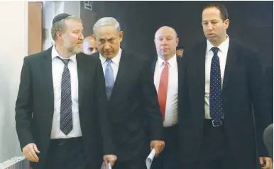  ?? (Marc Israel Sellem/The Jerusalem Post) ?? GIL SHEFFER (second from right) enters a cabinet meeting with Prime Minister Benjamin Netanyahu while he was serving as his chief of staff.