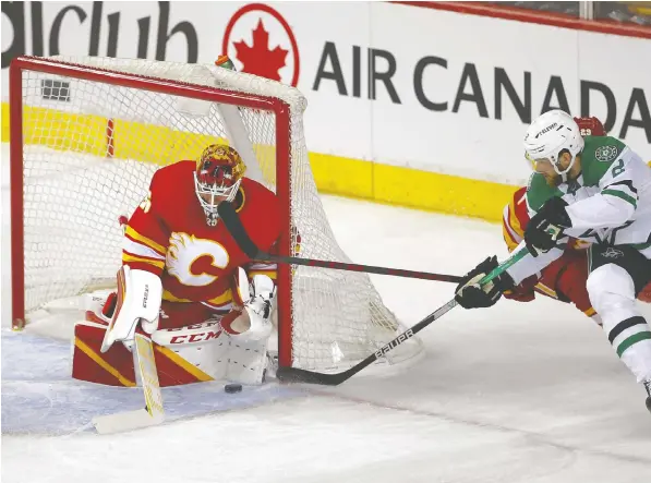  ?? DARREN MAKOWICHUK ?? Flames goalie Jacob Markstrom stops a shot from the Dallas Stars' Jani Hakanpaa during Game 5 of their best-of-seven first round series on Wednesday night at the Scotiabank Saddledome in Calgary. Markstrom made 20 saves in the win.