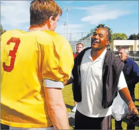  ??  ?? Associated Press File O.J. Simpson chats with then-southern Cal quarterbac­k Carson Palmer in December 2002 at a team practice in Davie, Fla., before the Orange Bowl.