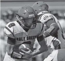  ??  ?? Sale Creek quarterbac­k Tanner Harvey, right, hands off to running back John Roberts during their Best of Preps football jamboree scrimmage.