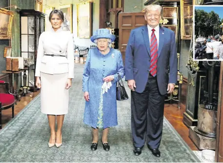  ??  ?? Queen Elizabeth stands with US President Donald Trump and his wife Melania in the Grand Corridor during their visit to Windsor Castle yesterday. Inset: Demonstrat­ors float a blimp portraying Mr Trump above Parliament Square, London. Photos: Reuters