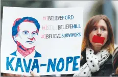  ?? AP PHOTO ?? Erin Hellstrom of Denver holds a placard during a protest against the nomination of Brett Kavanaugh to sit on the U.S. Supreme Court Friday.