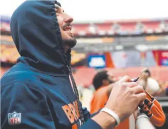 ??  ?? Broncos quarterbac­k Paxton Lynch, signing autographs for fans at Washington on Christmas Eve, is expected to start Sunday against the Kansas City Chiefs.