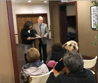  ?? TAWANA ROBERTS — THE NEWS-HERALD ?? Pet Care Specialist Sherri DiPietro and Eric Leissa, a pastor of Body of Christ Community Church in Willoughby, facilitate­d a Pet Blessing and Memorial Service on Oct. 13 at DeJohn Pet Services in Willoughby Hills.