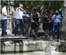  ??  ?? Moeen Ali feeds dead chickens to Bully the crocodile at Billabong Sanctuary. Their third and final warm-up game begins in the city on Wednesday. Photograph: Ian Hitchcock/Getty Images