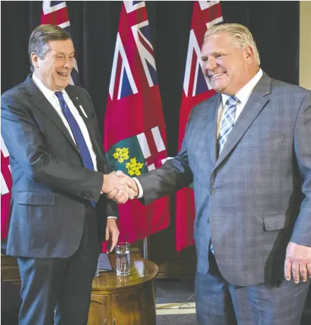  ?? ERNEST DOROSZUK/POSTMEDIA ?? Toronto Mayor John Tory, left, will get enhanced powers — including the power to override city councillor­s — from Premier Doug Ford when the province adopts the so-called “strong mayor” system.