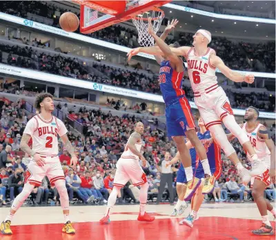  ?? CHRIS SWEDA/CHICAGO TRIBUNE ?? Chicago Bulls guard Alex Caruso (6) blocks the shot of Detroit Pistons guard Saben Lee (38) in the second half of a game at the United Center in Chicago on Oct. 23.