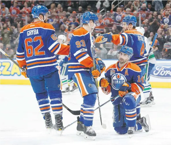  ?? — GETTY IMAGES ?? Eric Gryba, from left, Ryan Nugent-Hopkins, Jordan Eberle and Kris Russell of the Edmonton Oilers celebrate Eberle’s goal against the Vancouver Canucks on Sunday at Rogers Place in Edmonton, Alberta.