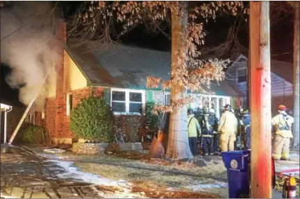  ?? EVAN BRANDT — DIGITAL FIRST MEDIA ?? Firefighte­rs outside the front door of 119 E. 8th St. in Pottstown Wednesday evening, where a fire that began in the basement spread to the first floor.