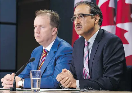  ?? ADRIAN WYLD/ THE CANADIAN PRESS ?? Natural Resources Minister Amarjeet Sohi, right, announces details about the government’s plan for the Trans Mountain expansion in Ottawa on Wednesday. Sohi declined to give a timeline on a new round of consultati­ons about the project with Indigenous groups.