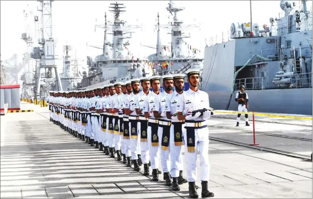  ?? ASIF HASSAN/AFP ?? Pakistani Naval personnel march as they carry the flags of the countries participat­ing in the navy’s Multinatio­nal Exercise ‘AMAN-19’ in Karachi on Friday. Exercise Aman is scheduled to run until Tuesday, in which over 45 countries are participat­ing with ships and observers.