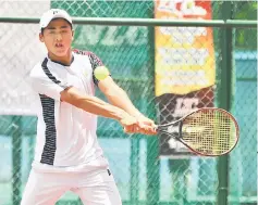  ??  ?? Naoki Tajima of Japan hits a return shot to Tasei Ichikawa during their third round boys’ singles match at SLTA Tennis Centre yesterday. Naoki won 6-2, 4-6, 7-5. — Photo by Teo Chi Wei