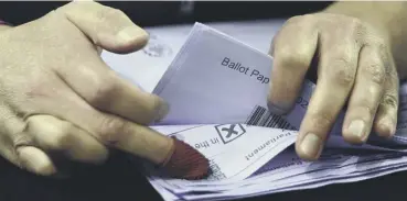  ??  ?? 0 A member of staff counts ballots at the Emirates Arena in Glasgow