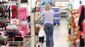  ?? — Reuters ?? A woman shops with her daughter at a Walmart Super centre in Rogers, Arkansas, US.