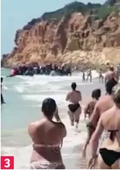  ??  ?? Hit the beach: Migrants pour ashore