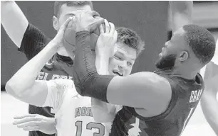  ??  ?? Florida State forward RaiQuan Gray (1) and North Carolina forward Walker Kessler (13) struggle for the ball during the first half in Chapel Hill, N.C., Saturday.