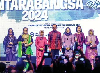  ?? — Bernama photo ?? Anwar and Nancy, on his right, in a stage photo-call with Manjeet (second left) and other award honourees during the national-level Internatio­nal Women’s Day 2024, at Sunway Pyramid Convention Centre.