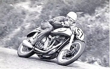  ??  ?? Poetry in motion. Geoff Duke approaches Kate’s Cottage on his way to winning his first Internatio­nal TT, the 1950 Senior. His one-piece leathers were worth about 1mph, which may not sound a lot but in a seven lap TT (almost three hours in those days) Geoff was crossing the finish line while a similarly talented opponent wearing convention­al clothing of the day would still be at Creg-ny-Baa. Having viewed this photograph after the race, Geoff commission­ed the manufactur­e of tailored boots to further reduce wind resistance and save more precious seconds. How’s that for pursuing perfection.