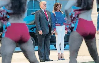  ??  ?? Vestida de Super Bowl Donald i Melania Trump, davant un grup de cheerleade­rs. La primera dama dels EUA va portar una caçadora de setí combinada amb sabates de Louboutin