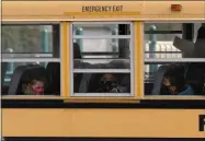  ?? NAM Y. HUH — THE ASSOCIATED PRESS FILE ?? On Nov. 19, 2020, elementary school students sit on board a school bus after attending in-person classes at school in Wheeling, Ill.