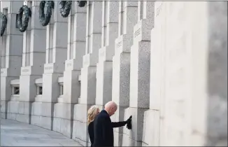  ?? Evan Vucci / Associated Press ?? President Joe Biden and first lady Jill Biden visit the National World War II Memorial to mark the 80th anniversar­y of the Japanese attack on Pearl Harbor on Tuesday in Washington.