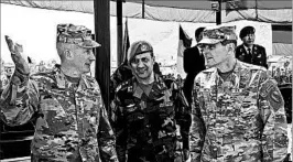  ?? LOLITA BALDOR/AP ?? Gen. John Nicholson, left, top U.S. commander in Afghanista­n, talks Sunday with Afghan Col. Khanullah Shuja and Gen. Joseph Votel, head of U.S. Central Command, near Kabul.