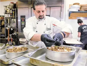  ?? Jerry Baker / For the Chronicle ?? Drew Rogers, pastry chef and owner of Drew’s Pastry Place, works on one of his Sticky Toffee Cheesecake­s in his kitchen. Rogers will be participat­ing in The Woodlands Wine & Food Week “Just Desserts” competitio­n June 1-7.