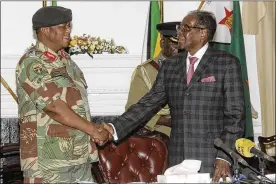  ?? ASSOCIATED PRESS ?? Zimbabwean President Robert Mugabe (right) shakes hands with army Gen. Constantin­o Chiwenga before delivering a speech during a live broadcast at State House in the nation’s capital, Harare, on Sunday. Mugabe baffled the country by delivering his...