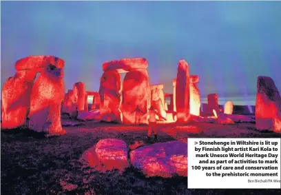  ?? Ben Birchall/PA Wire ?? > Stonehenge in Wiltshire is lit up by Finnish light artist Kari Kola to mark Unesco World Heritage Day and as part of activities to mark 100 years of care and conservati­on to the prehistori­c monument