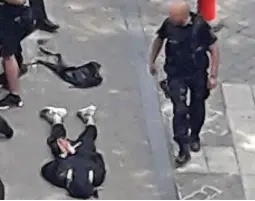  ??  ?? Aftermath: The gunman lies sprawled on the street