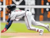  ?? THE ASSOCIATED PRESS ?? The Atlanta Braves’ Ronald Acuna Jr. dives into second base for a double against the Philadelph­ia Phillies on Sunday in Philadelph­ia. The Braves won 10-1.