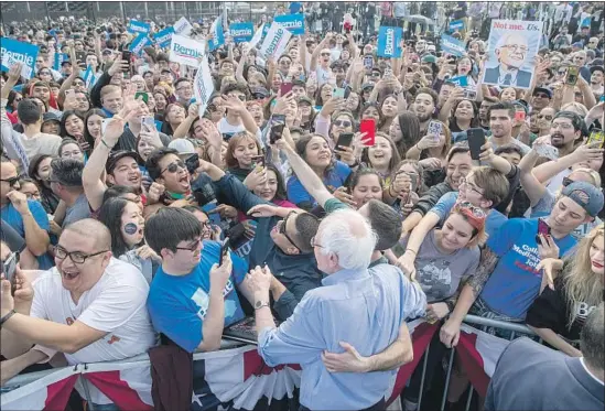  ?? ALLEN J. SCHABEN Los Angeles Times ?? DEMOCRATIC presidenti­al candidate Bernie Sanders, center foreground, greets supporters in Santa Ana on Feb. 21. Sanders made frequent visits to California.